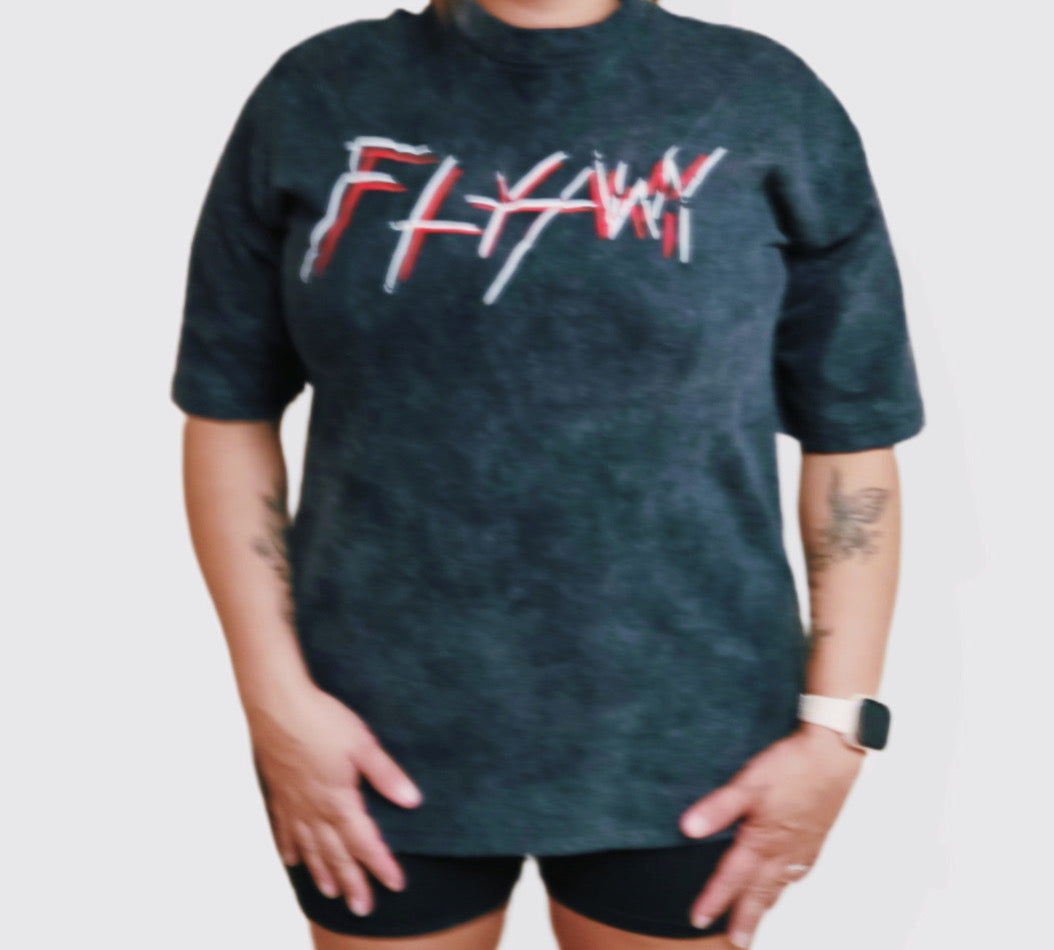 Oversized black acid-washed heavyweight tee with red and white "FLYAWY" graphic text on front.
