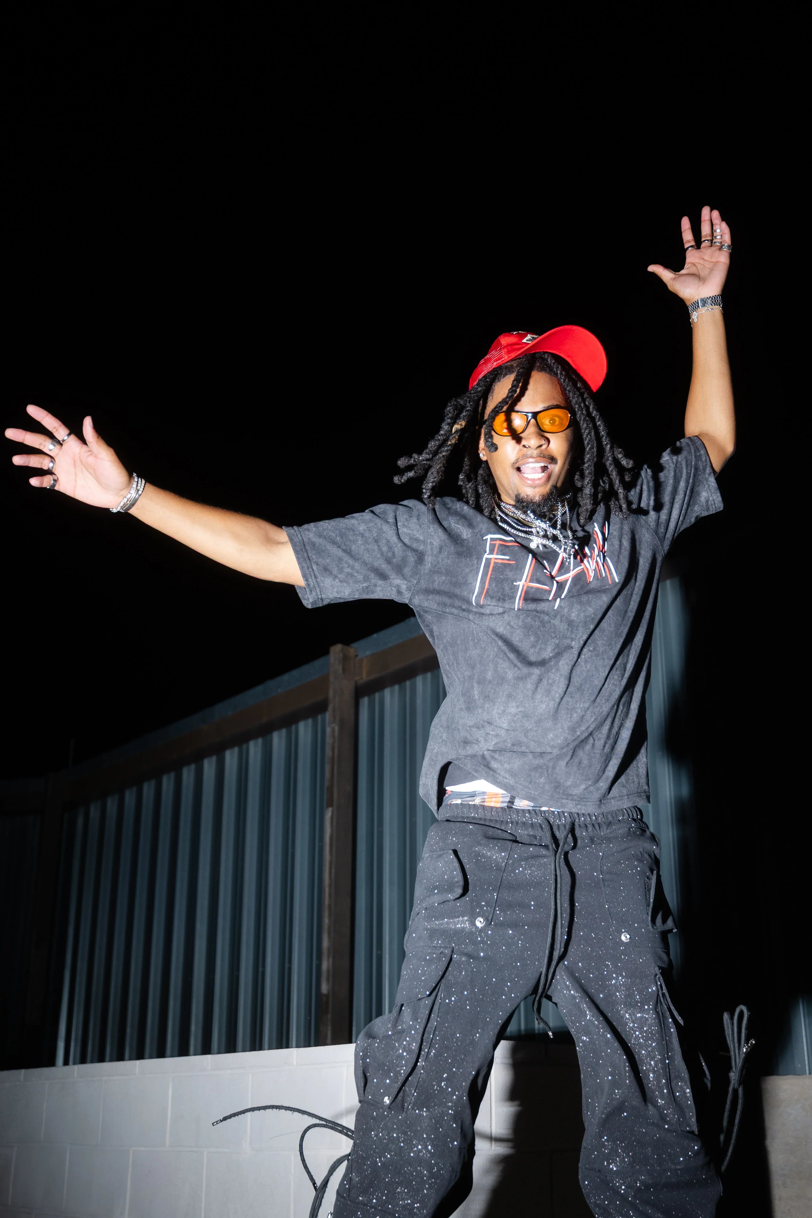 Oversized acid-washed gray heavyweight tee with red and white graphic text on front.