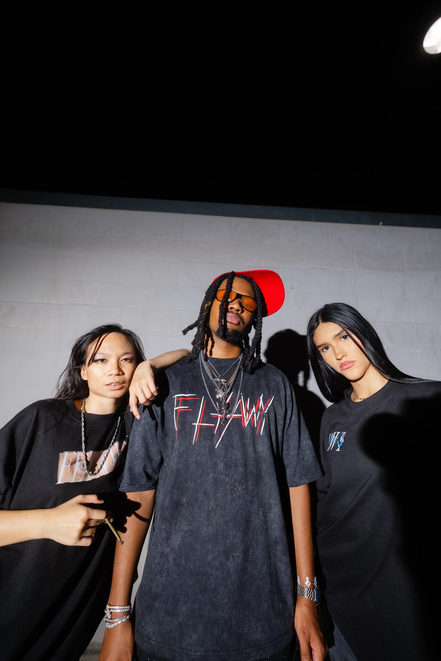 Oversized black heavyweight tee with red "FLY AWAY" graphic across the chest.