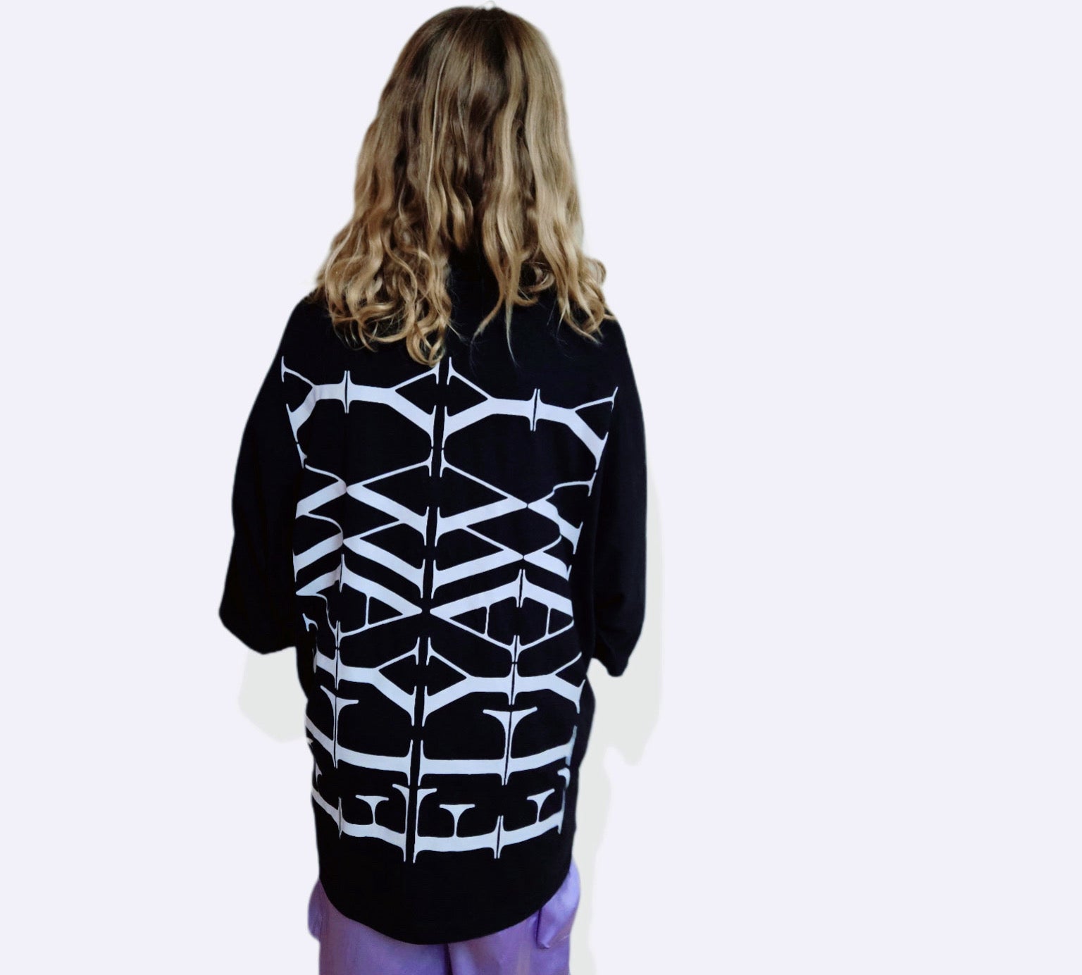 Black oversized heavyweight T-shirt with abstract white geometric graphic on the back and dropped shoulders.