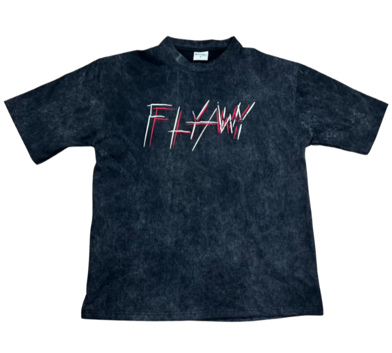Oversized acid-washed black heavyweight tee with "FLYAWY" red and white graphic text on front.